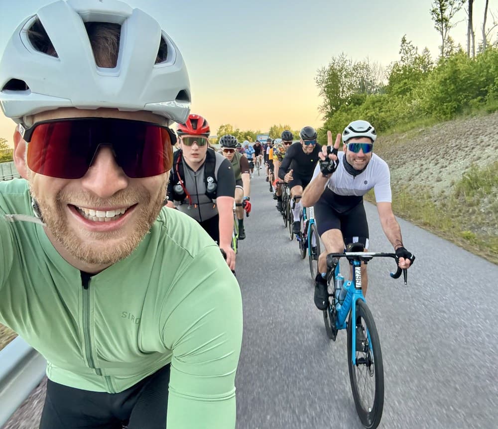 Sven riding in a group of road cyclists in the morning light