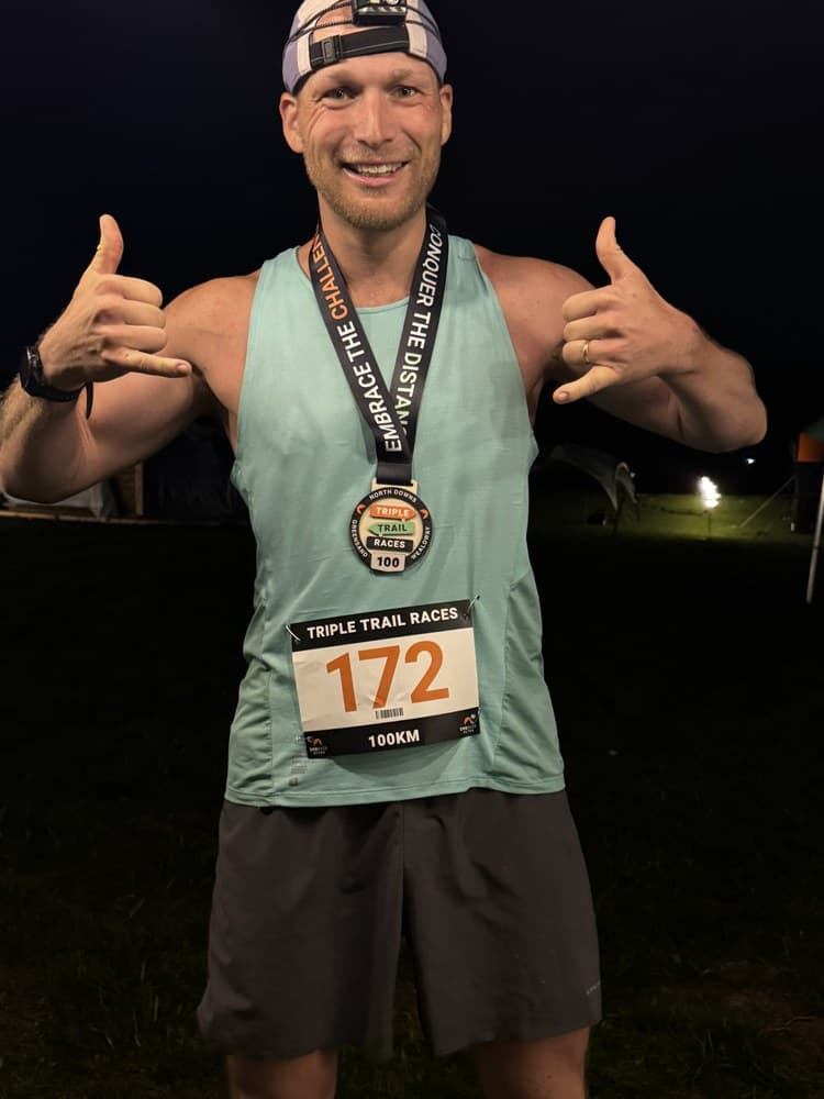 Sven at night at the Triple Trail Ultra finish with his medal